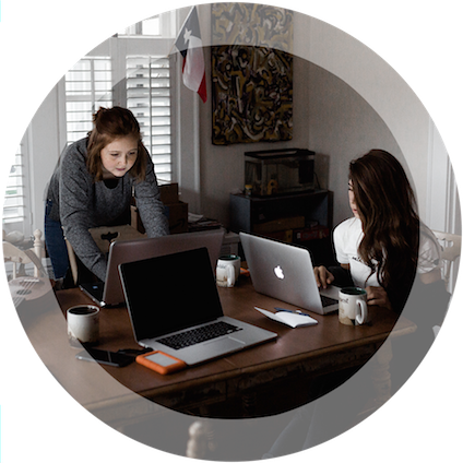 Two women sharing a work space